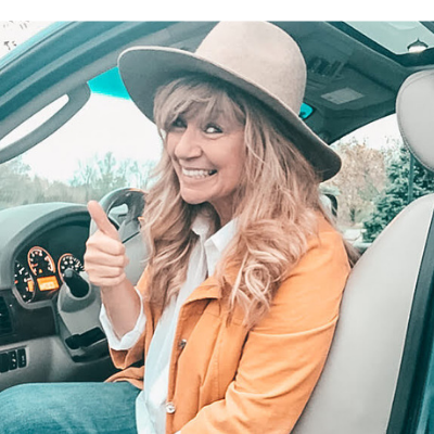 woman in hat giving thumbs up