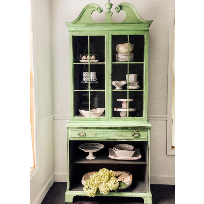 green Cabinet with white dishes
