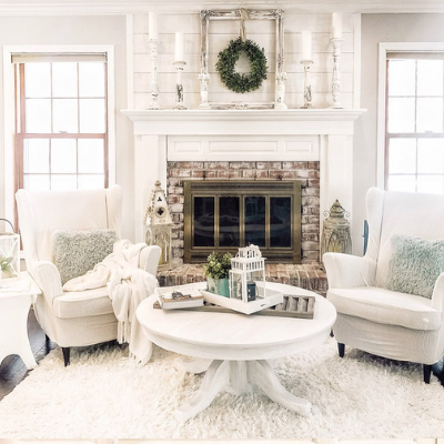 white room with armchairs and fireplace