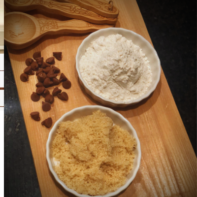 chocolate chips flour and sugar on a cutting board