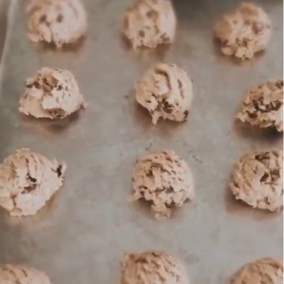 balls of chocolate chip cookie dough on sheet cake pan