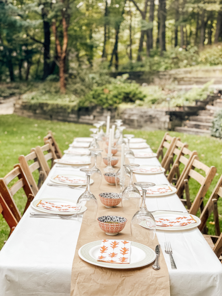 long table with white cloth in the backyard